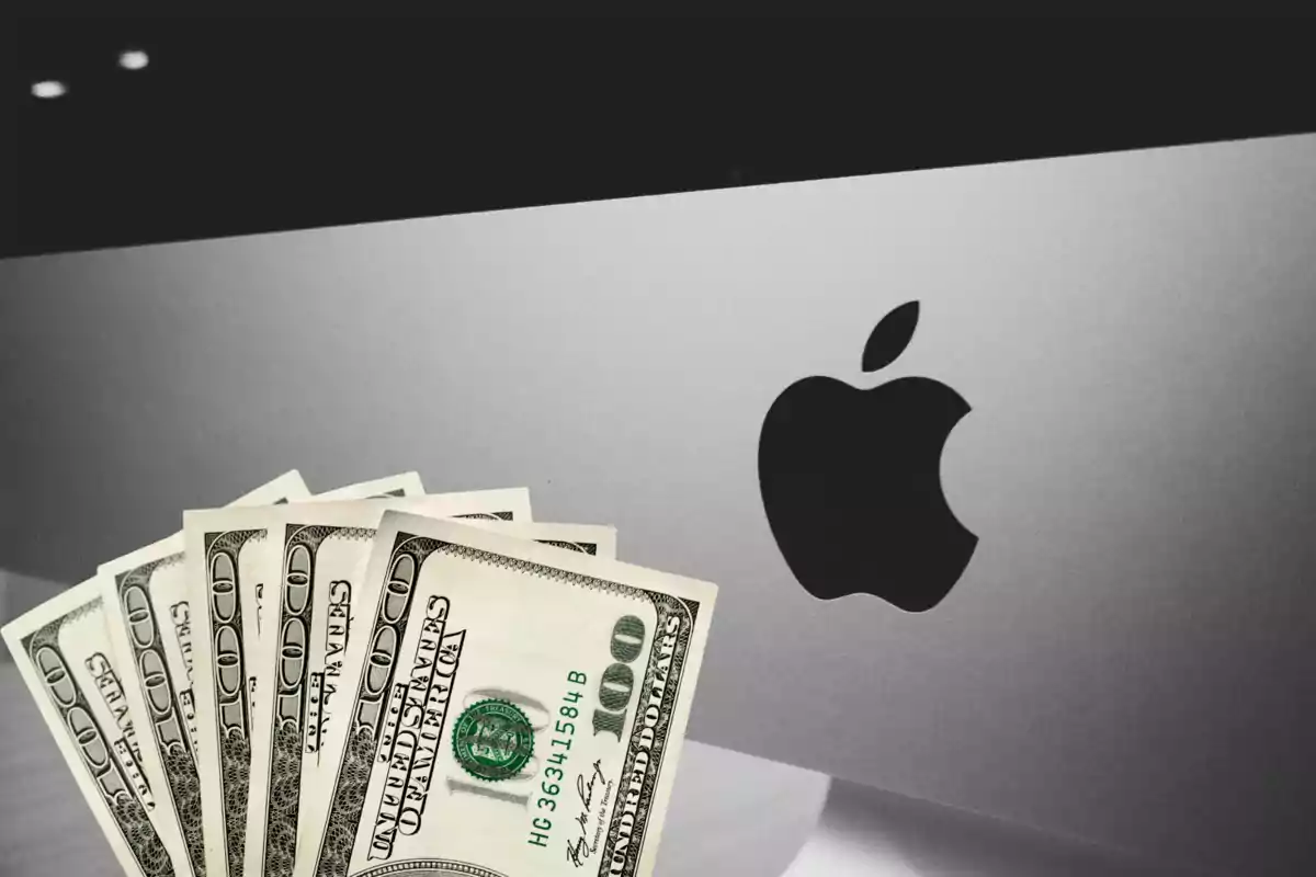 Hundred-dollar bills in front of an Apple computer Hundred-dollar bills in front of an Apple computer
