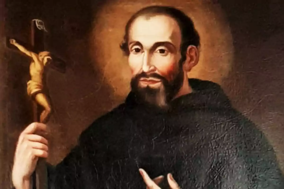 Retrat d’un frare amb barba i hàbit fosc sostenint un crucifix