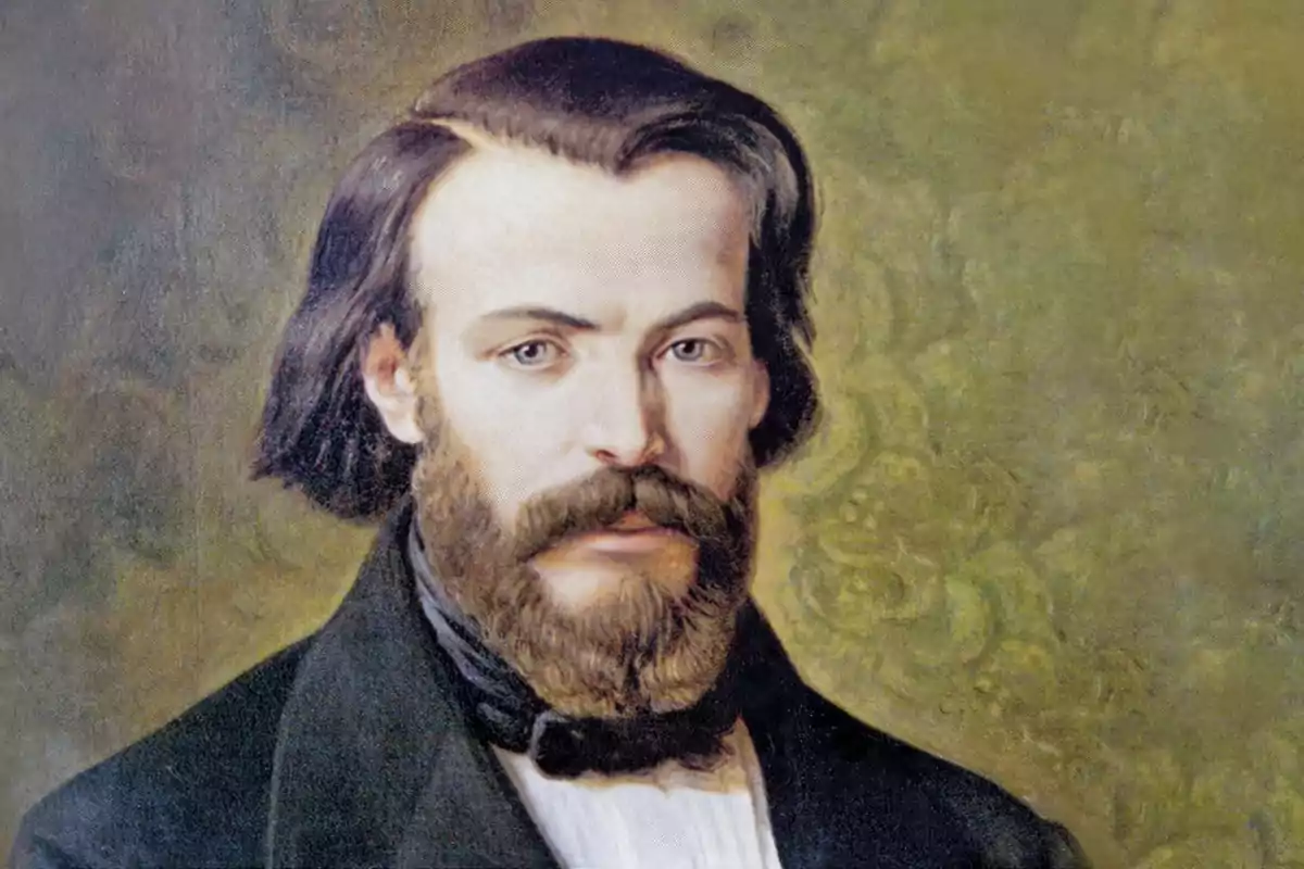 Retrat d’un home amb barba i cabells foscos vestit amb jaqueta negra i fons de color verd difuminat Retrat d’un home amb barba i cabells foscos vestit amb jaqueta negra i fons de color verd difuminat