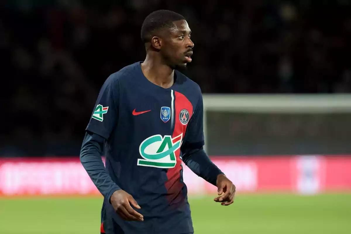 Ousmane Dembélé wearing PSG’s blue and red uniform on the field during a match Ousmane Dembélé wearing PSG’s blue and red uniform on the field during a match