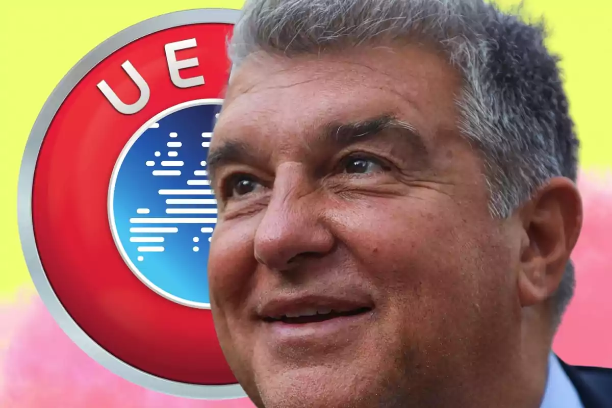 Smiling gray-haired man in the foreground with a blurred UEFA logo in the background against a yellow and pink backdrop.