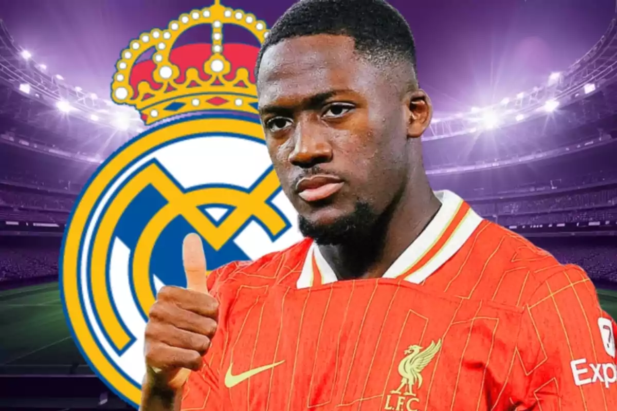 Soccer player wearing a Liverpool jersey giving a thumbs-up gesture in front of the Real Madrid crest in a brightly lit stadium