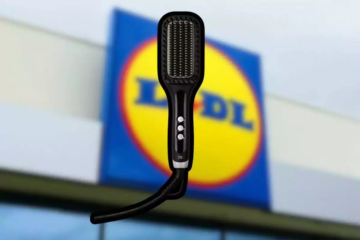 Black electric straightening brush with buttons on the handle in front of a blurry Lidl store sign Black electric straightening brush with buttons on the handle in front of a blurry Lidl store sign