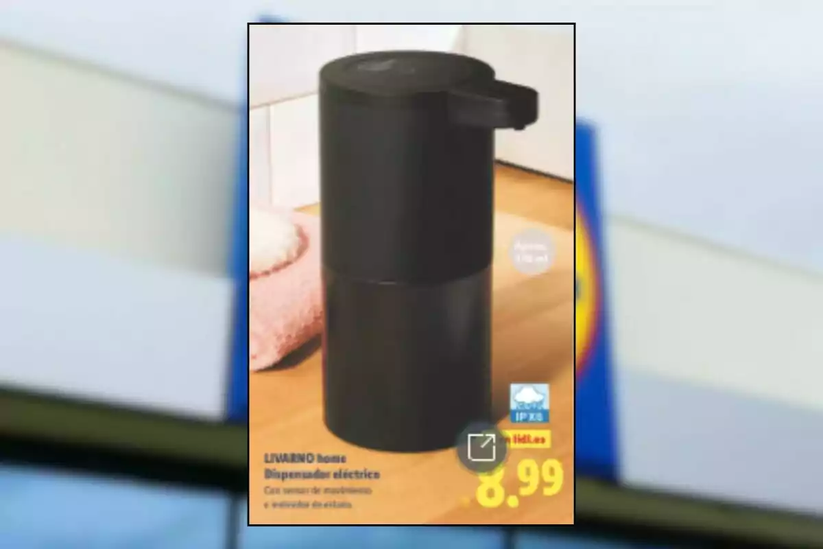 Black electric dispenser device on a wooden table next to a pink towel with a price of 8.99 euros Black electric dispenser device on a wooden table next to a pink towel with a price of 8.99 euros