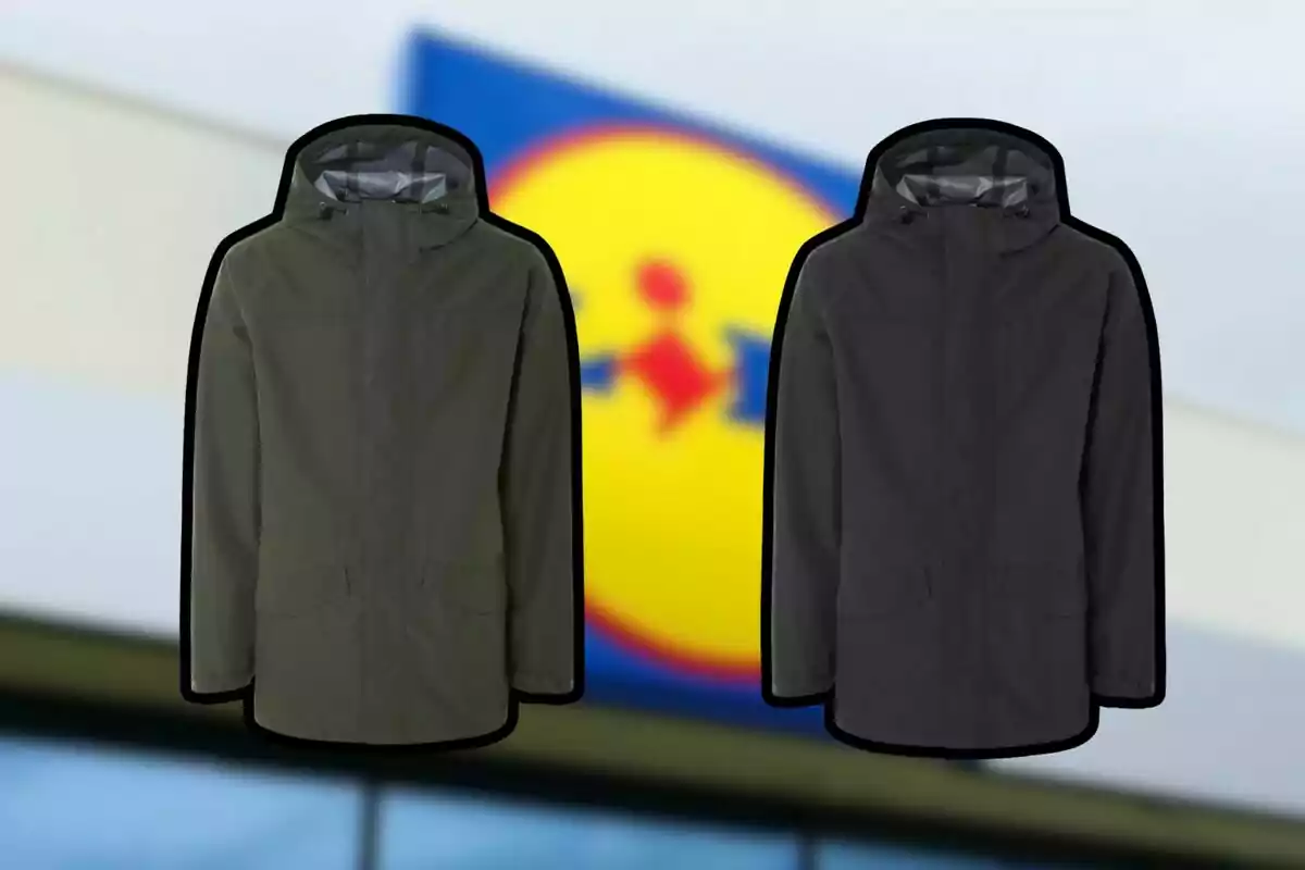 Two hooded jackets in dark colors are in front of a blurred background with a store logo.