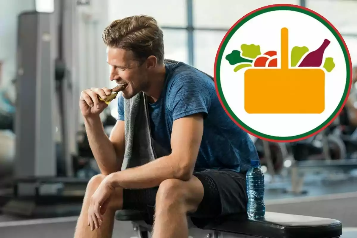 Hombre sentado en un gimnasio comiendo una barra energética con una botella de agua a su lado y un gráfico de canasta de alimentos en la imagen