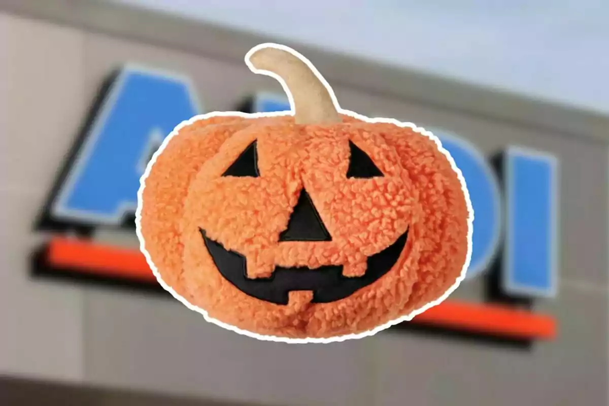Plush pumpkin with a Halloween face on a blurry store background Plush pumpkin with a Halloween face on a blurry store background