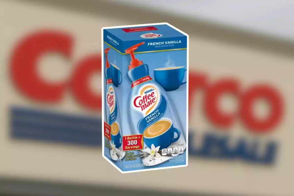 Box of French Vanilla Coffee Mate with a blue coffee cup and a vanilla flower in front, against a blurred background of a Costco store