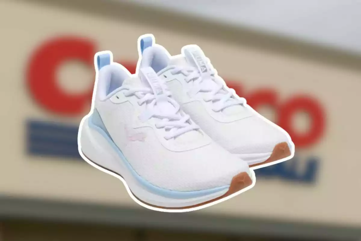 A pair of white Puma athletic sneakers with light blue accents and a brown sole in front of a blurred background of a Costco store A pair of white Puma athletic sneakers with light blue accents and a brown sole in front of a blurred background of a Costco store
