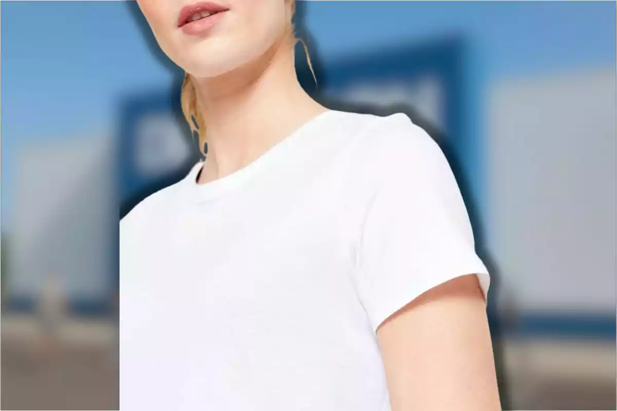 Mujer con camiseta blanca de manga corta en un entorno urbano desenfocado