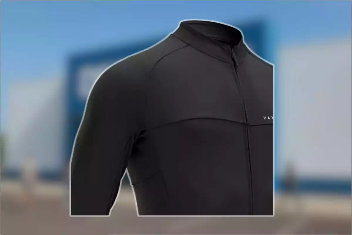 Detalle de una chaqueta deportiva negra con cierre frontal y fondo desenfocado