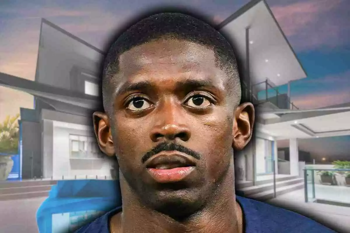 Close-up of Ousmane Dembélé with a serious expression in front of a blurred modern house at sunset