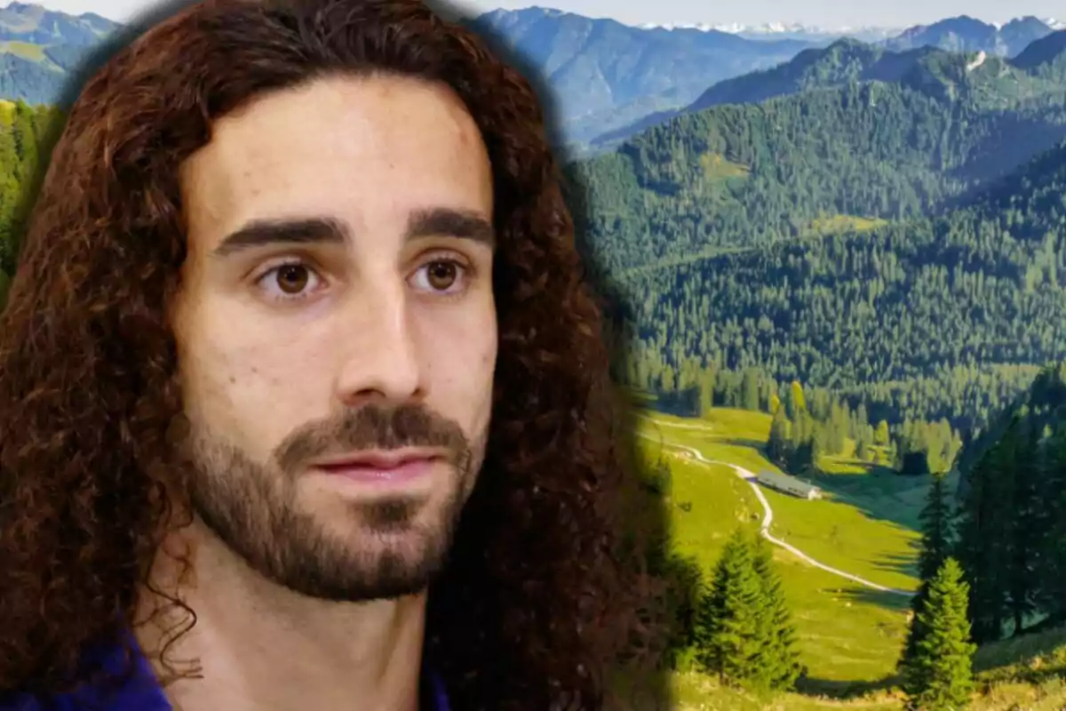 Marc Cucurella in front of a mountainous landscape with trees and a winding path