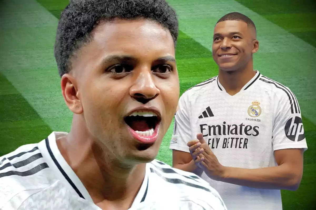 Two players in white Real Madrid uniforms on a grass field, one in the foreground celebrating and another in the background smiling and applauding.