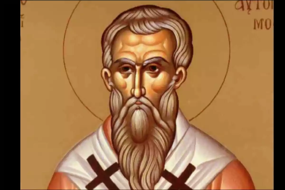Icona religiosa d’un home amb barba llarga i túnica blanca amb creus negres sobre un fons daurat Icona religiosa d’un home amb barba llarga i túnica blanca amb creus negres sobre un fons daurat