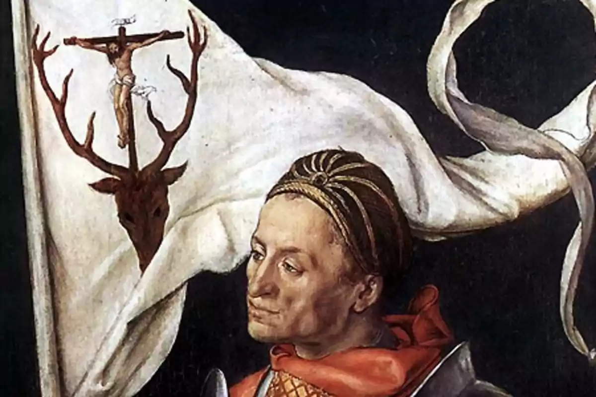 Hombre con vestimenta medieval frente a una bandera blanca que muestra la cabeza de un ciervo con una cruz y una figura crucificada sobre sus astas Hombre con vestimenta medieval frente a una bandera blanca que muestra la cabeza de un ciervo con una cruz y una figura crucificada sobre sus astas