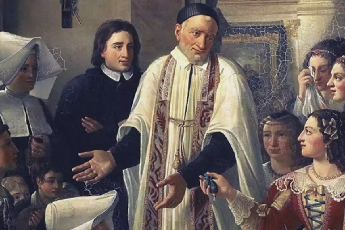 Un sacerdote con vestimenta blanca rodeado de varias personas, algunas de ellas mujeres con cofia blanca y otras con vestidos antiguos, en una escena de ayuda o caridad dentro de un edificio antiguo. Un sacerdote con vestimenta blanca rodeado de varias personas, algunas de ellas mujeres con cofia blanca y otras con vestidos antiguos, en una escena de ayuda o caridad dentro de un edificio antiguo.