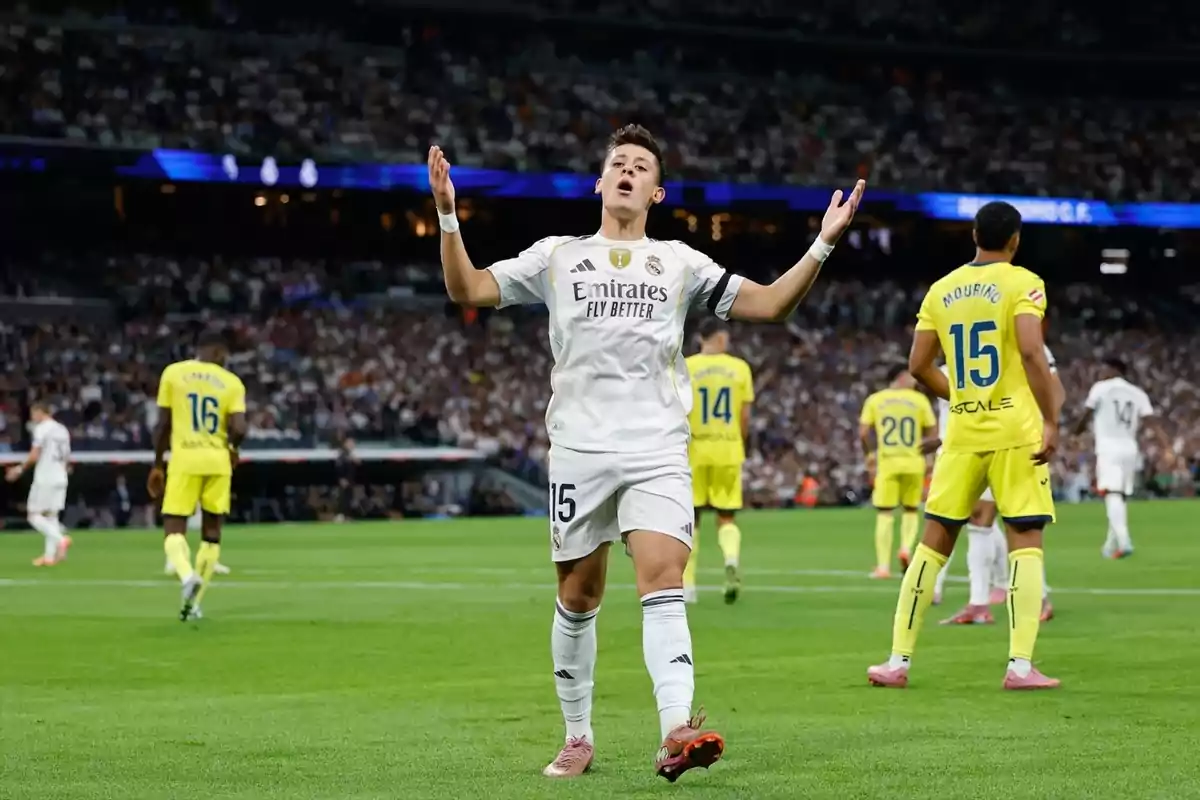 Real Madrid player celebrating on the field during a match against a team in yellow uniforms, with a stadium full of fans in the background