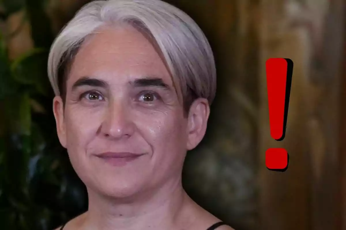 Persona de cabello canoso corto con un signo de exclamación rojo al lado sobre un fondo desenfocado.