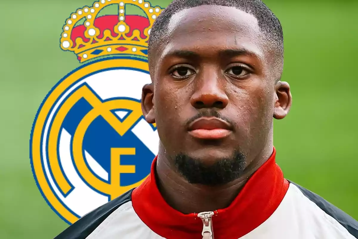 Soccer player with a tracksuit jacket in front of the Real Madrid crest