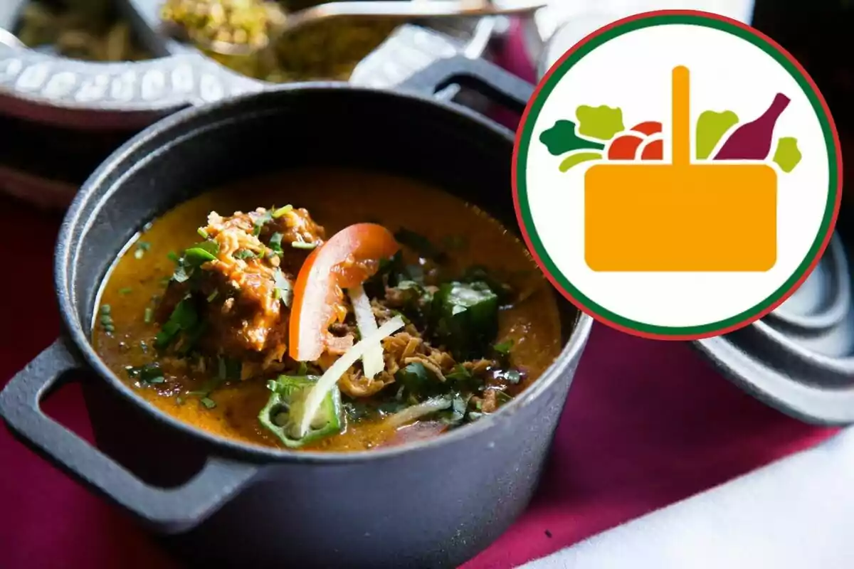 Estofat servit en una olla de ferro al costat d’un gràfic de cistella amb aliments