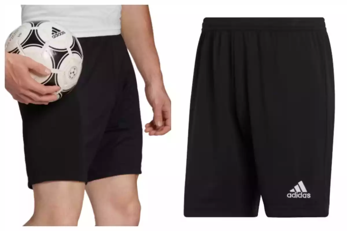 Pantaló esportiu curt negre Adidas amb logotip blanc i persona sostenint una pilota de futbol. Pantaló esportiu curt negre Adidas amb logotip blanc i persona sostenint una pilota de futbol.