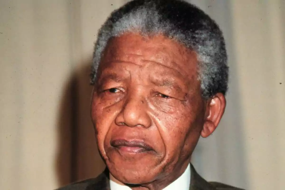 Nelson Mandela amb els cabells canosos i expressió seriosa amb fons neutre. Nelson Mandela amb els cabells canosos i expressió seriosa amb fons neutre.