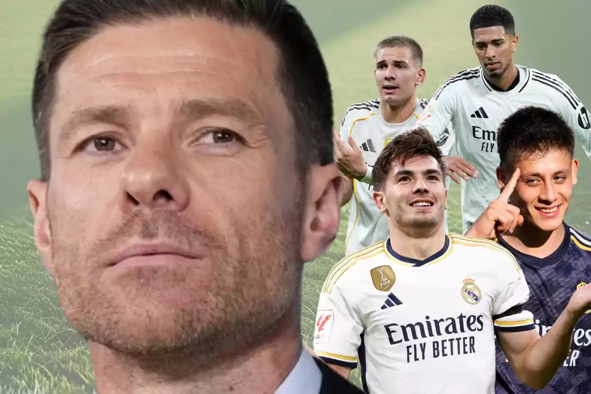 Primer pla d’un home amb expressió seriosa i al fons diversos jugadors del Reial Madrid celebrant i somrient en un camp de gespa desenfocat