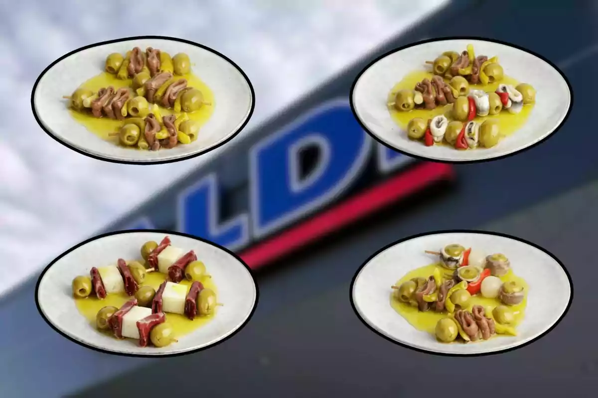 Cuatro platos con diferentes pinchos de aceitunas, anchoas, queso, pimientos y otros ingredientes sobre un fondo desenfocado de un letrero. Cuatro platos con diferentes pinchos de aceitunas, anchoas, queso, pimientos y otros ingredientes sobre un fondo desenfocado de un letrero.