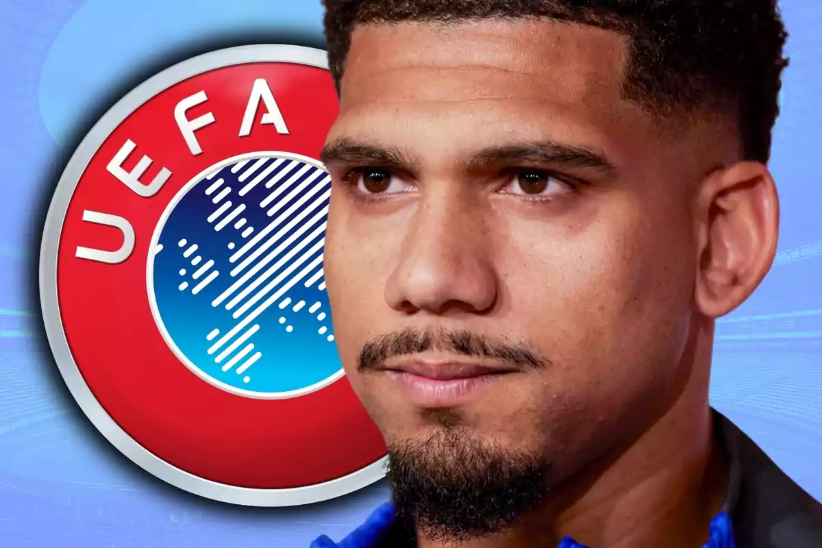 Hombre de cabello corto y barba recortada con el logo de la UEFA de fondo