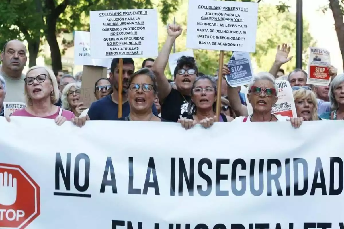 Grupo de personas manifestándose en la calle con pancartas y un cartel grande que dice No a la inseguridad
