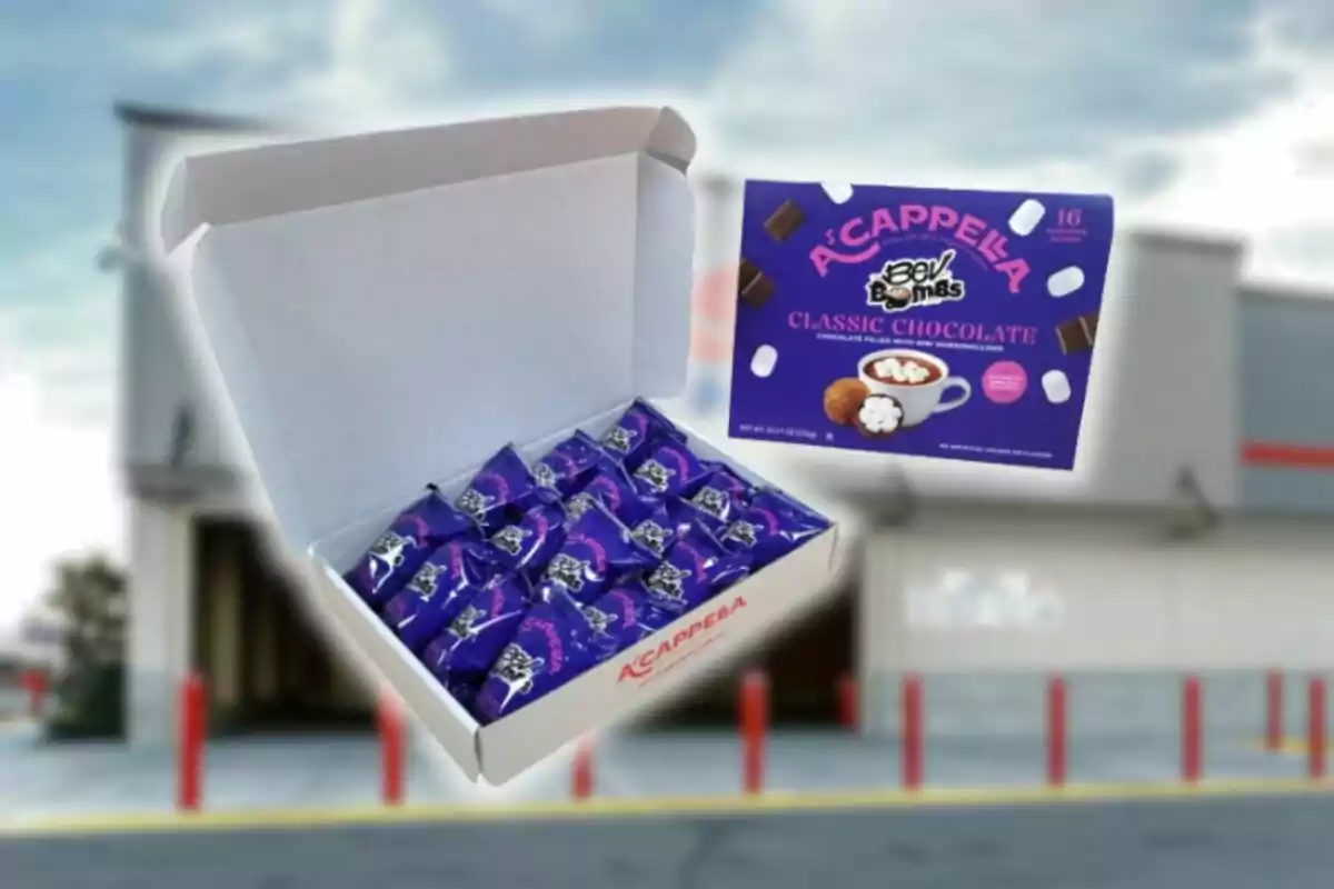 Open box with several individual packages of Acappella Bev Bombs chocolates from Costco and a display box of the same chocolates on a blurred store background.