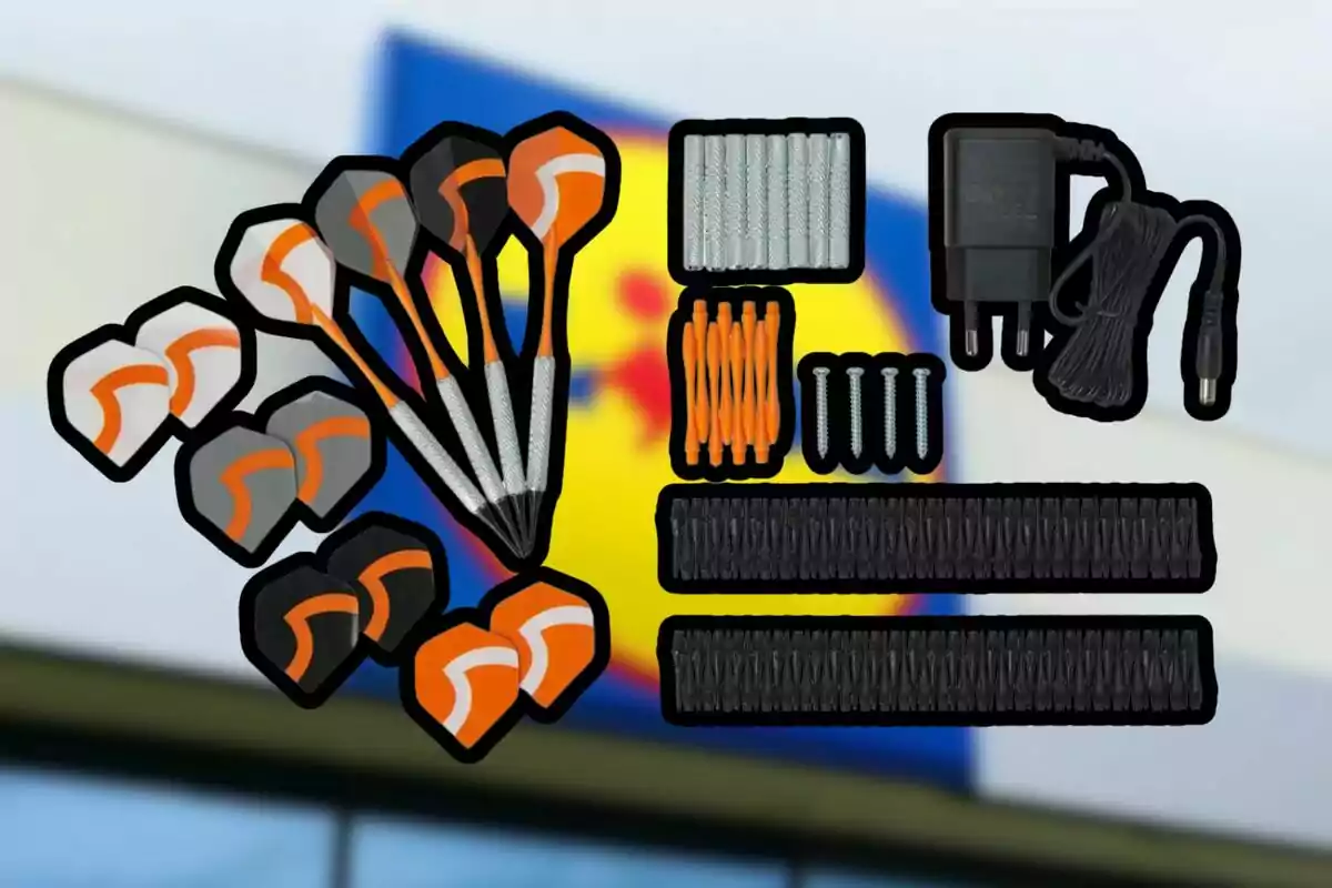 Kit de dards amb accessoris i carregador elèctric sobre un fons desenfocat d’un rètol de supermercat