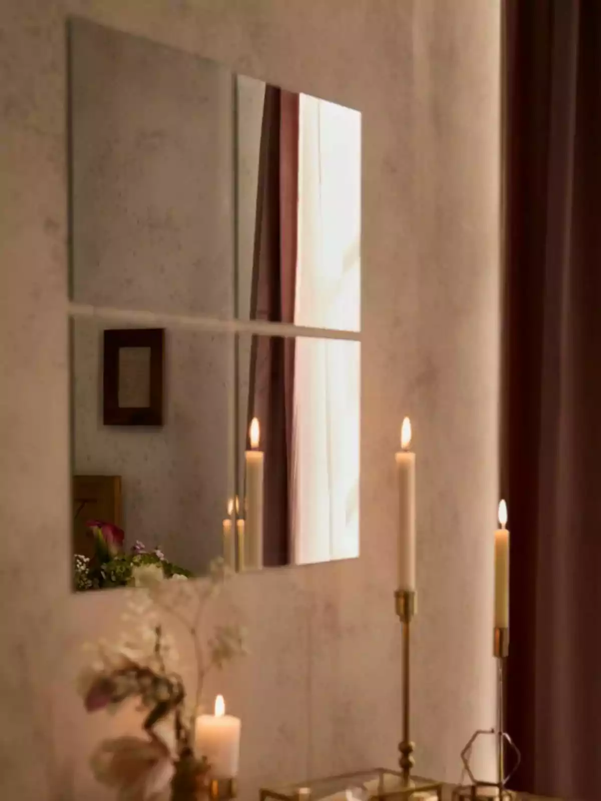 Four square mirrors on a wall reflect curtains, lit candles, and elegant decor with flowers and golden candle holders. Four square mirrors on a wall reflect curtains, lit candles, and elegant decor with flowers and golden candle holders.
