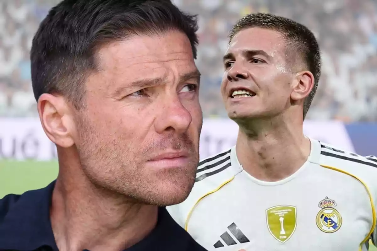 Primer plano de un hombre de cabello corto y barba junto a un jugador de fútbol con uniforme blanco del Real Madrid en un estadio lleno de público