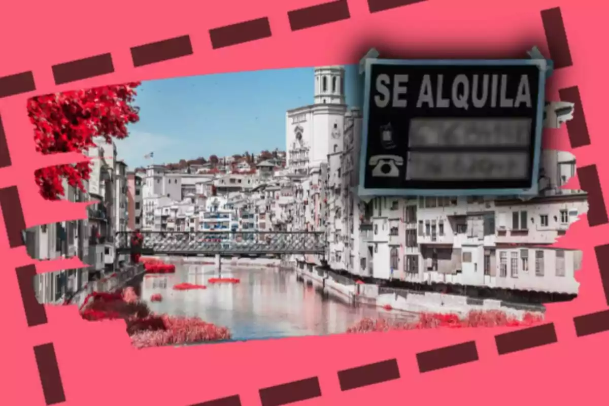 Vista de Girona amb cases al costat d’un riu i un cartell de "Es lloga" en primer pla sobre un fons rosa.