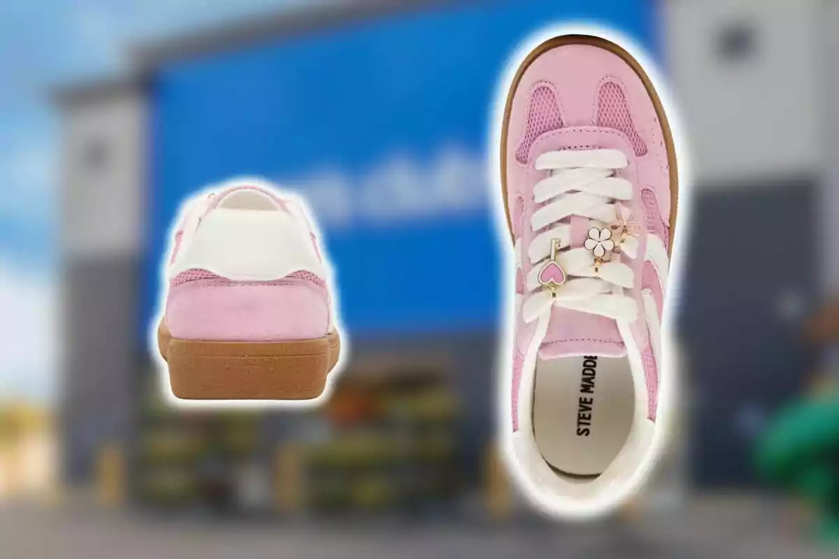 Pink athletic sneakers with white details and decorative charms on the laces against a blurred background of a Sam's Club store.