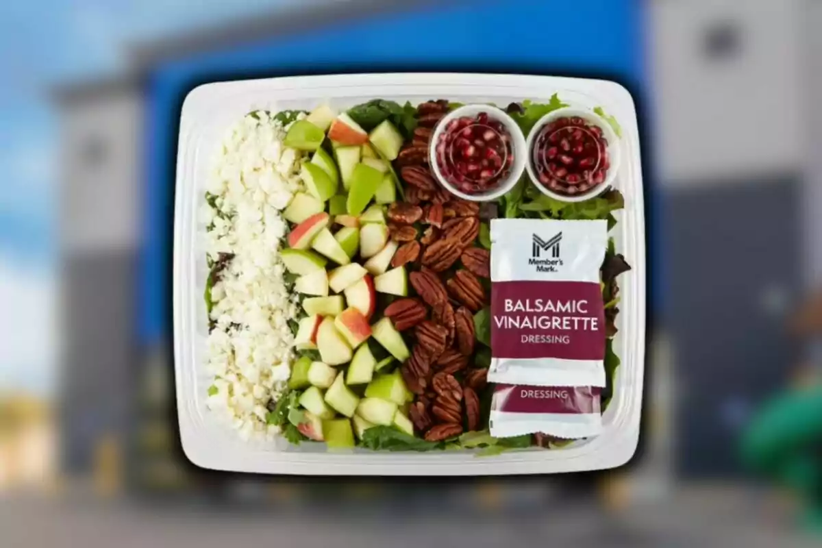 Sam's Club salad in a plastic container with cheese, apple, walnuts, pomegranate seeds, and balsamic dressing. Sam's Club salad in a plastic container with cheese, apple, walnuts, pomegranate seeds, and balsamic dressing.