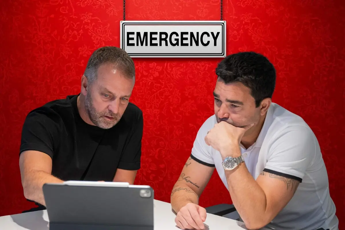 Dos homes concentrats revisen informació en una tauleta sota un rètol que diu EMERGENCY sobre una paret vermella