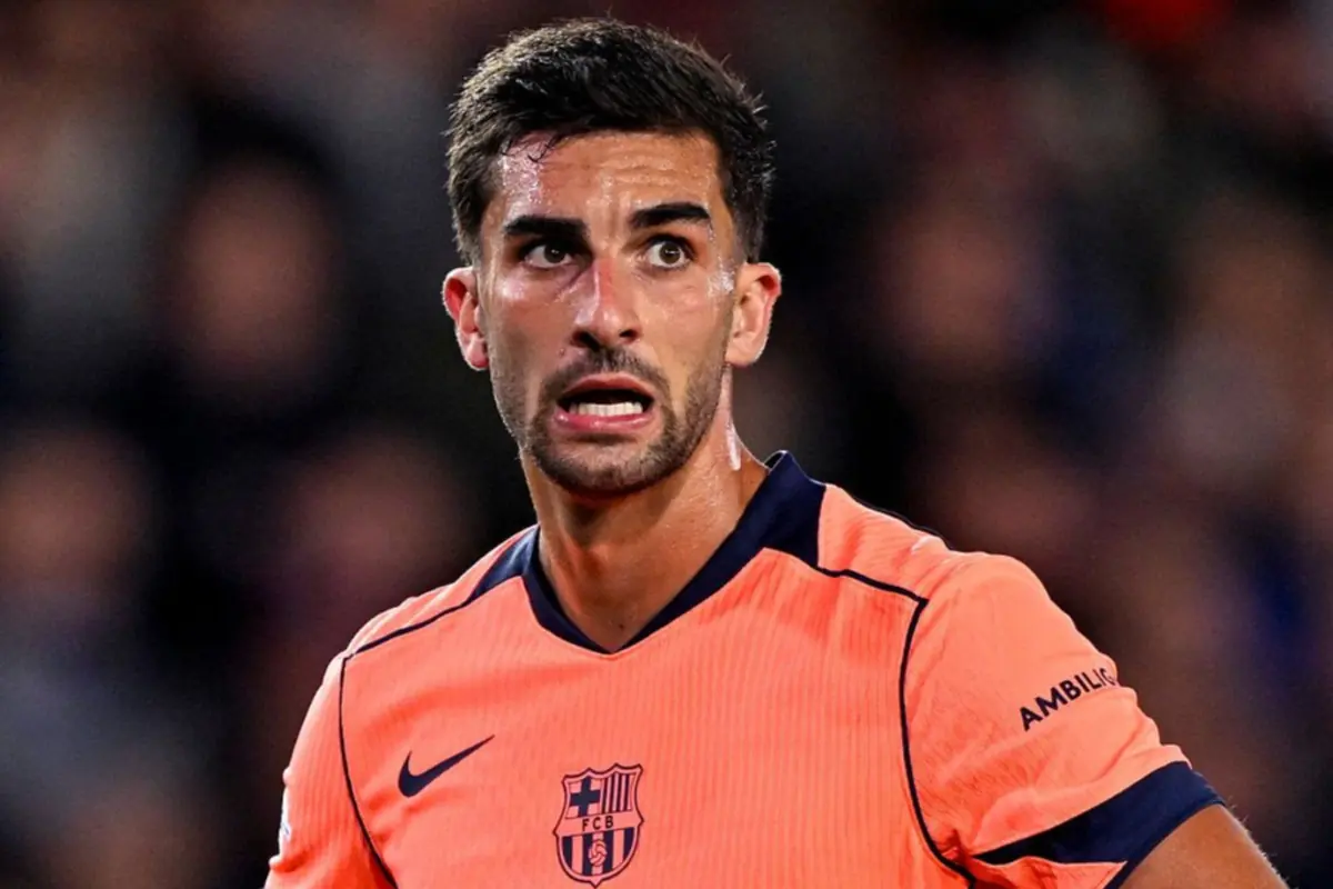 Soccer player with a surprised expression wearing an orange FC Barcelona uniform during a match