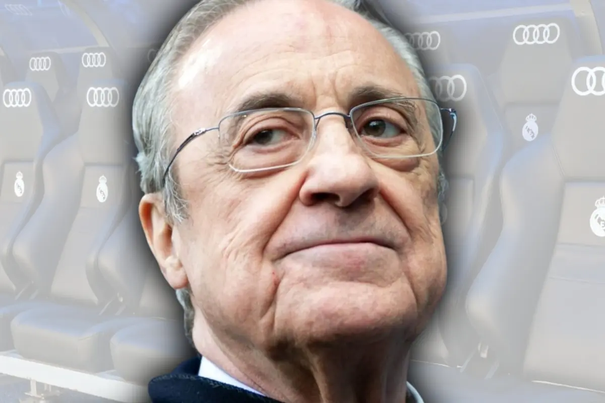 Older man with glasses and a serious expression in front of football stadium seats with Audi and Real Madrid logos.