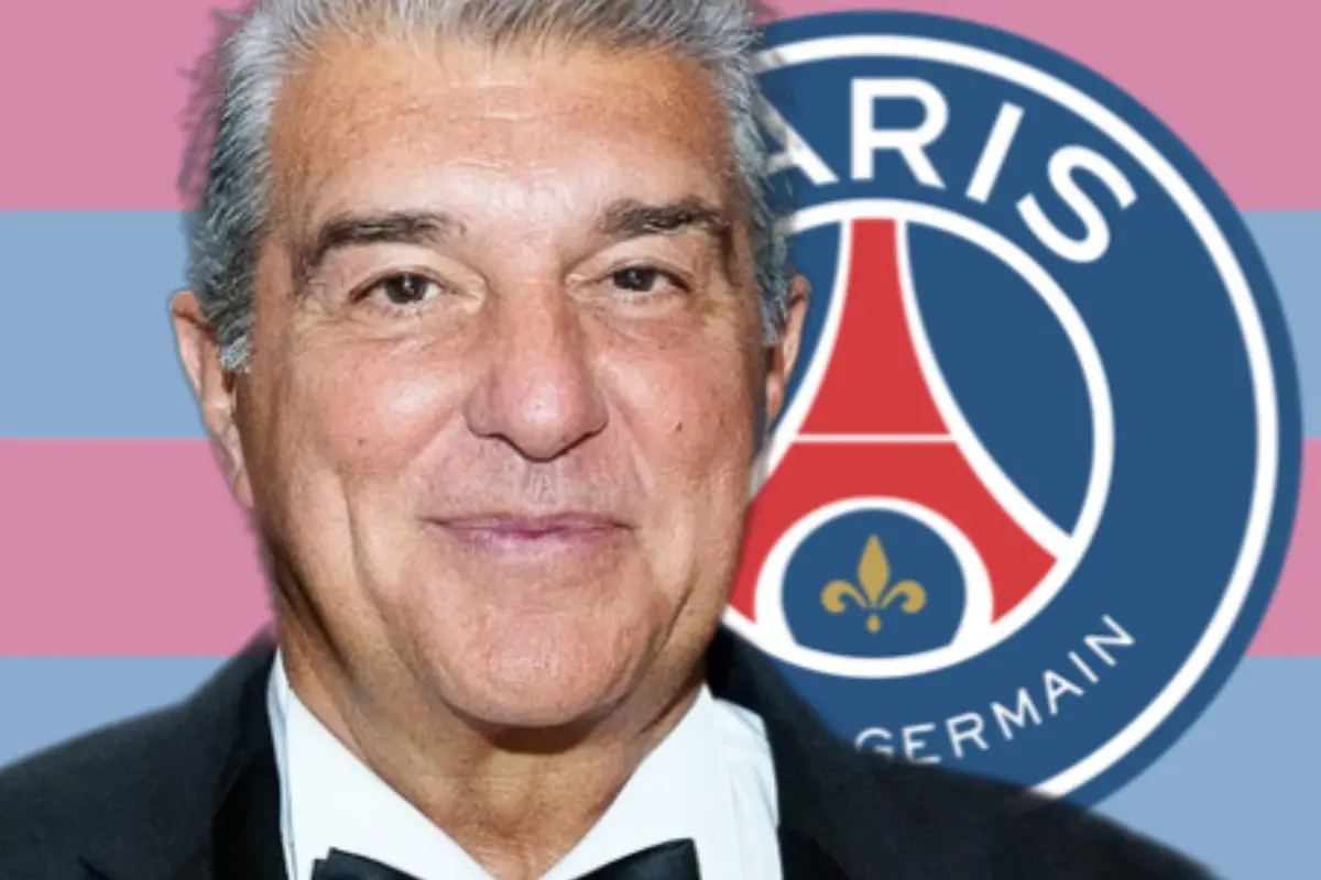 Gray-haired man in a tuxedo in front of the PSG crest with a background of blue and pink stripes