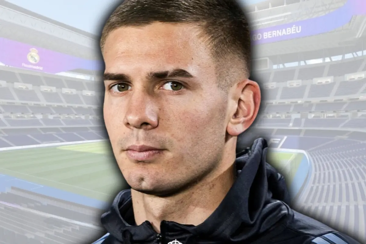 Primer pla d’un futbolista amb dessuadora fosca sobre un fons difuminat de l’estadi Santiago Bernabéu