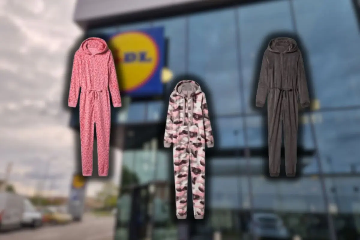 Three one-piece pajama monkeys in pink, camouflage print, and gray colors against a blurred background of a supermarket facade
