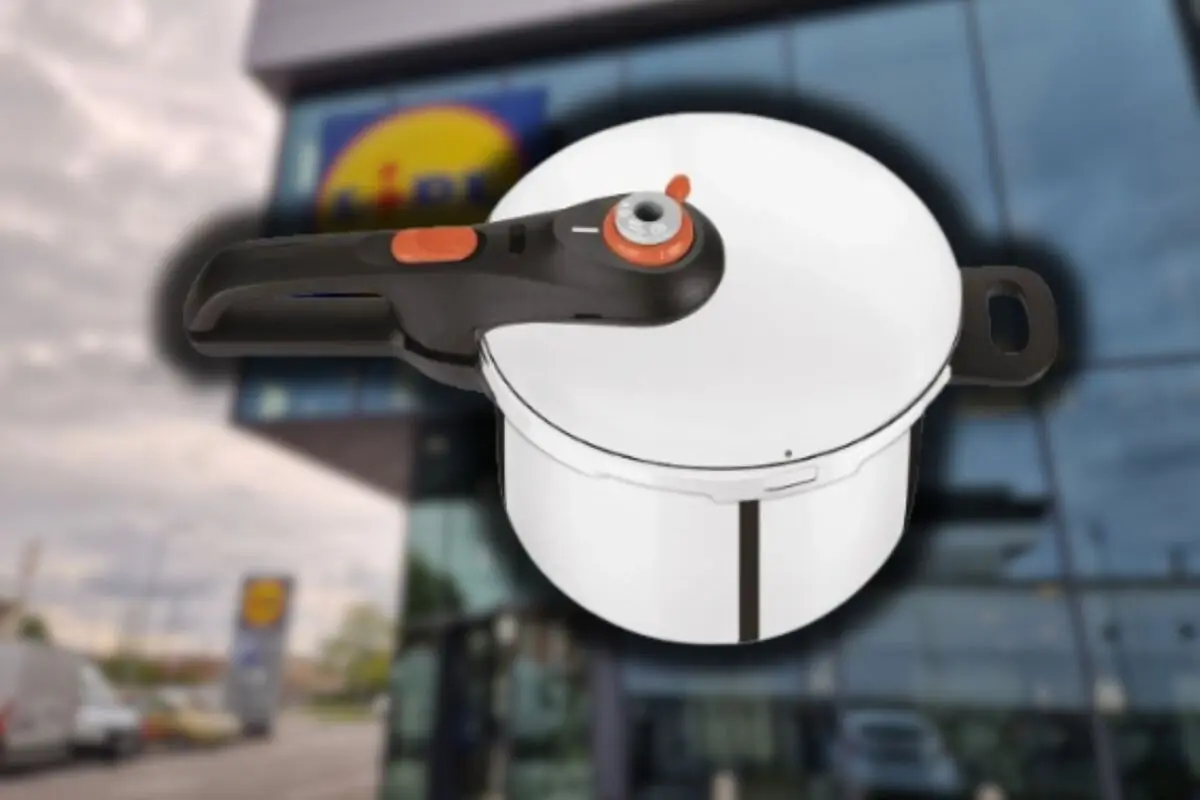 Metal pressure cooker with lid and black handle featured on the facade of a supermarket