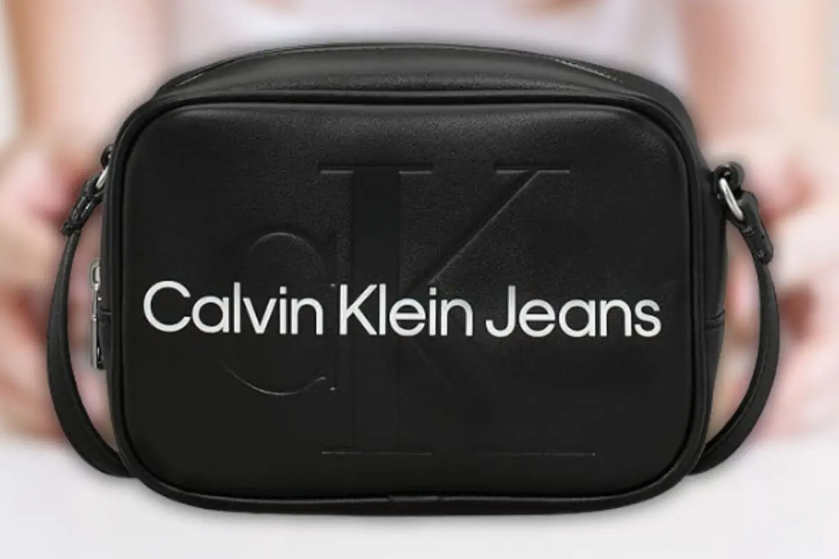 Bossa bandolera negra de pell sintètica amb el logotip Calvin Klein Jeans en blanc a la part frontal