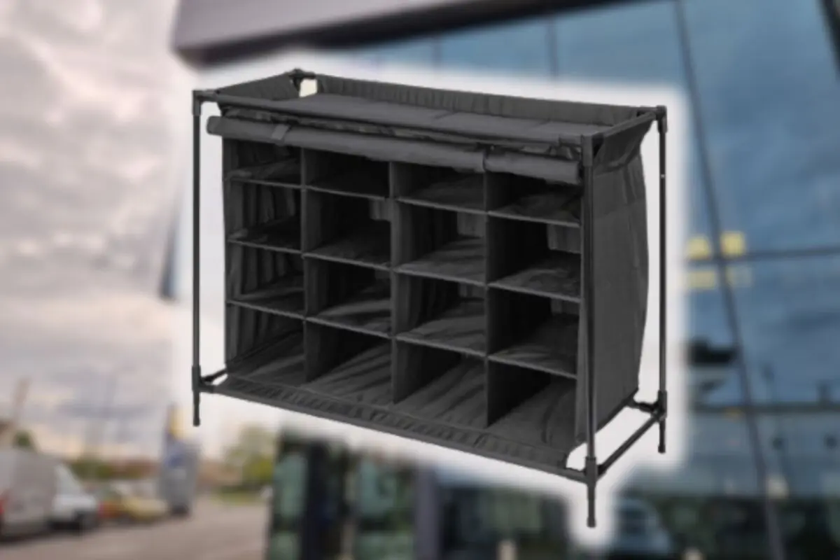 Black fabric organizer with multiple rectangular compartments on a lightweight metal frame with a blurred urban background