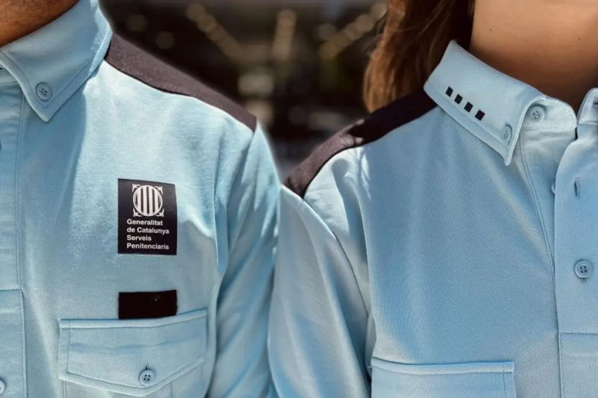Primer plano de dos personas con camisas azul claro de los Serveis Penitenciaris de la Generalitat de Catalunya mostrando el uniforme oficial