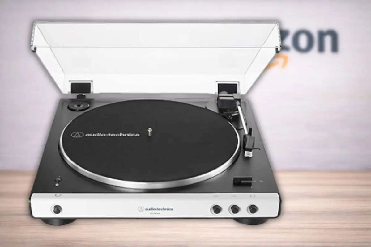 Tocadiscos Audio Technica de diseño moderno con tapa transparente sobre mesa de madera