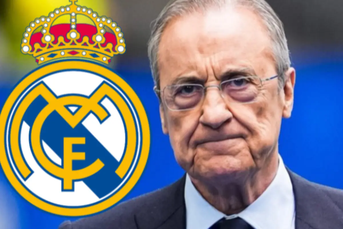 Home gran amb gest seriós al costat de l’escut del Reial Madrid sobre fons blau